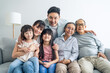 © Kawee - Portrait of Asian happy family sit on sofa and smile, look at camera.