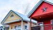 Pano Two storey homes with balconies snowy gable roofs and garages at the facade