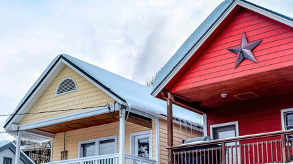 Wall Mural - Pano Two storey homes with balconies snowy gable roofs and garages at the facade