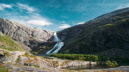 Wall Mural - Kinsarvik, Hordaland, Norway. Waterfall Sotefossen In Hardangervidda Mountain Plateau. Famous Norwegian Landmark And Popular Destination In Spring Sunny Day. .4K, Time Lapse, Timelapse, Time-lapse