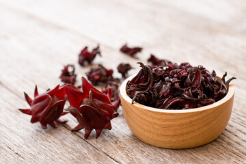 Wall Mural - Fresh and dry Roselle fruit (Jamaica sorrel, Rozelle or hibiscus sabdariffa) in wooden bowl 