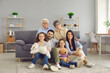 © Studio Romantic - Portrait of a big family spending time together at home. Elderly grandparents, young parents and children are having a happy time. Big happy family of different generations