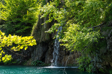  Waterfall with turquoise water in the Plitvice Lakes National Park, Croatia.