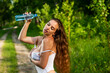 © Михаил Решетников - Beautiful caucasian woman sprays herself with water for freshness on a hot summer day.