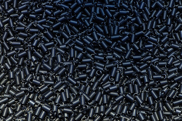 Many industrial small hard spring coil on black color background