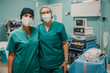 © Gabriel Trujillo - Portrait of medical nurses looking at camera inside operating theater at private clinic - Focus on right doctor face