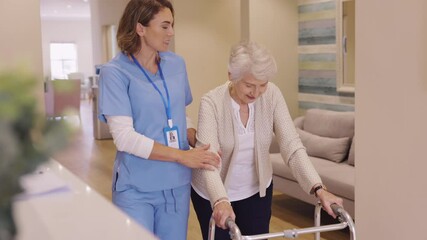 Wall Mural - Nurse helping senior woman to walk at private clinic