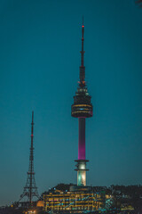 Wall Mural - Vertical shot of illuminated Seoul Tower at night