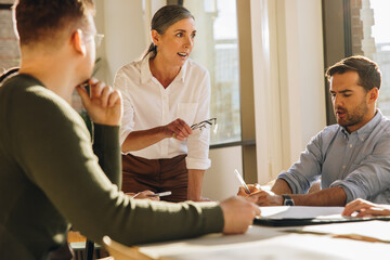 Wall Mural - Businesswoman brainstorming with team in meeting