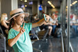 © Angelov - tourism, vacation, childhood and transportation concept - smiling little girl with travel bag, ticket and passport over airport background.