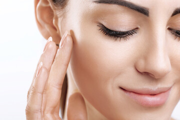 Poster - Closeup happy young woman applying cream to her face Skincare and cosmetics concept. Cosmetics. Woman face skin care.Natural makeup, touching face.