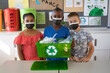 © Wavebreak Media - Group of diverse students wearing face masks holding a tray filled with recyclable plastic items