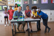© Wavebreak Media - Portrait of caucasian male teacher and group of diverse boys smiling during environment class