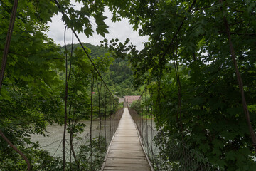  Suspension bridge across mountain river in Maramures