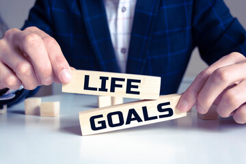 Wall Mural - Wooden block with words LIFE GOALS on the white background