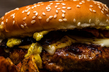 Poster - Fresh tasty beef cheeseburger with melted cheese isolated on black background