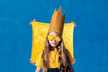 Teenager In Crown And Sunglasses On Blue Background