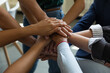 © fizkes - Business team stack of hands. Group of employees joining hands together, expressing respect, trust, support, keeping teambuilding, motivation, community spirit, celebrating success. Close up