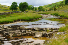 Low Water Level Revealing Jagged Rocks On The River Wharfe, Kettlewell, Upper Wharfedale, North Yorkshire, England, UK.1