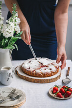 Woman Slicing Strawberry Cake