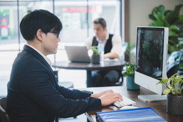 Wall Mural - confident professional businessman working with laptop in modern business office workplace, executive manager man with computer technology, male businessman entrepreneur startup