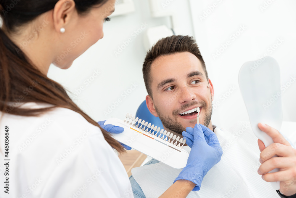 Man in stomatology clinic. Teeth whitening. - obrazy, fototapety, plakaty 