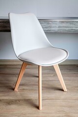 Wall Mural - White leather armchair with brown wooden legs in a modern home living room