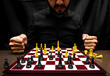 © Narayan - latin man with beard challenging in chess game, chess concept