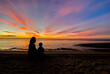 © kowitstockphoto - silhouette of family watching sunset at the beach in Hua Hin