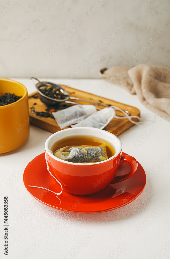 Cup with tea bag on light background - obrazy, fototapety, plakaty 