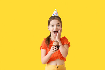 cute little girl celebrating birthday on color background
