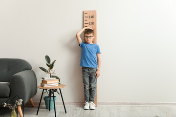 Poster - Little boy measuring height at home