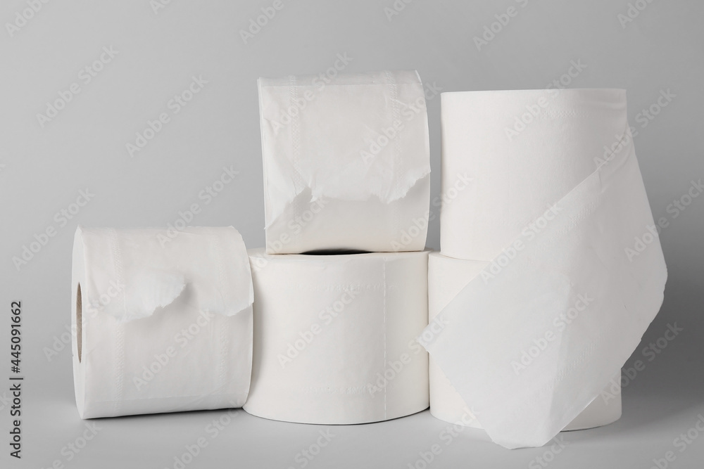 Rolls of toilet paper on grey background