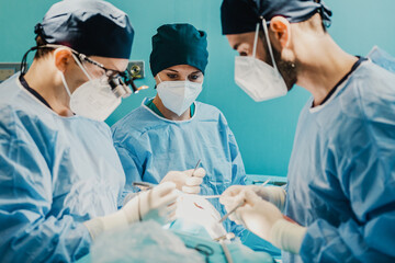 Wall Mural - Medical doctors team operating patient in surgical room at hospital - Focus on nurse woman face