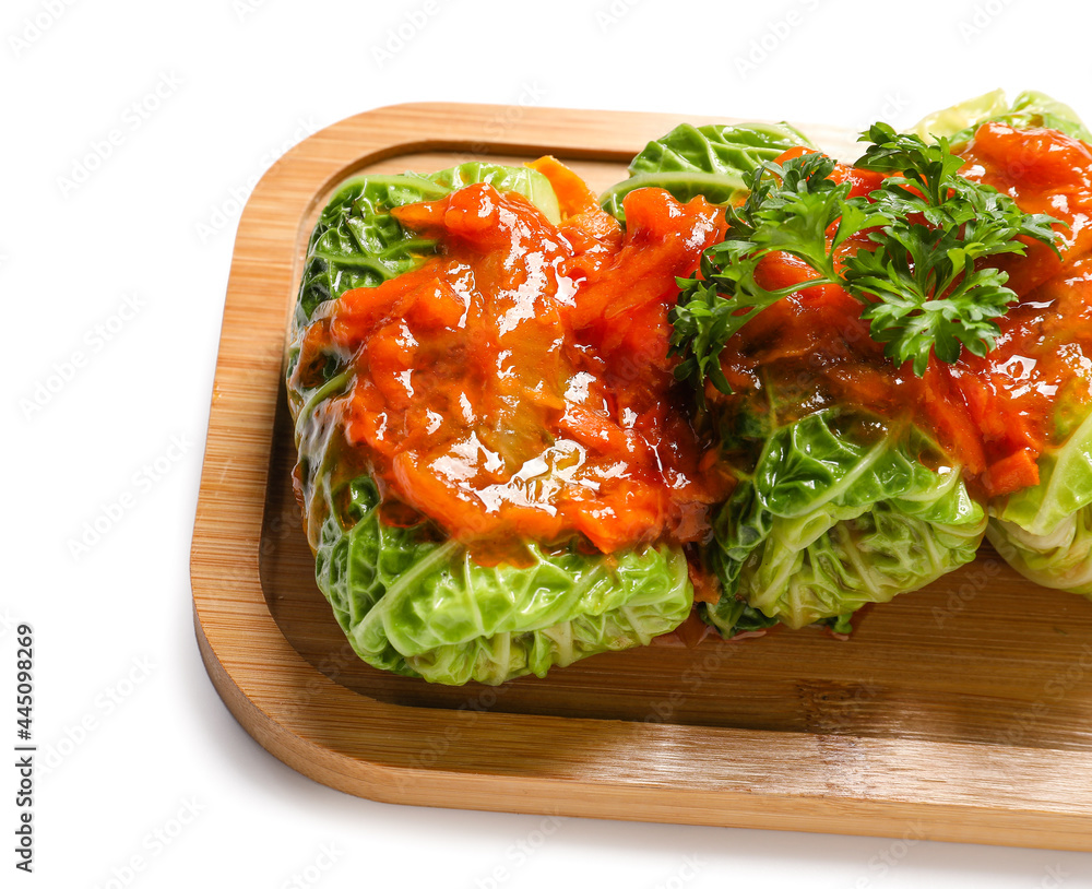 Board with stuffed cabbage leaves with tomato sauce on white background, closeup
