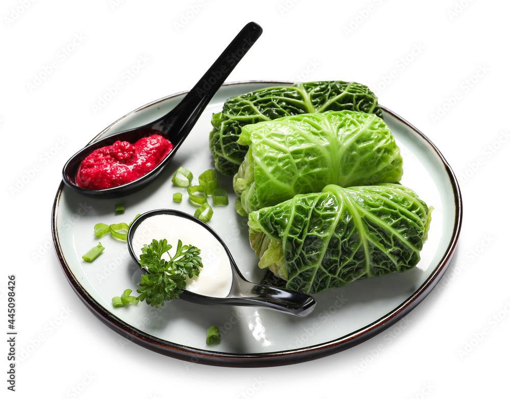 Plate with stuffed cabbage leaves, sour cream and sauce on white background