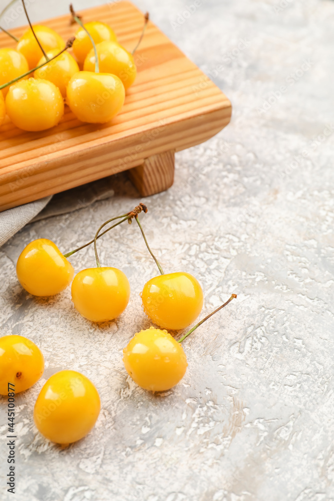 Tasty sweet cherries on grunge background
