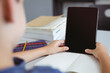 © WavebreakMediaMicro - Caucasian schoolboy in classroom sitting at desk using tablet, with copy space on screen