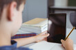 © WavebreakMediaMicro - Caucasian schoolboy in classroom sitting at desk using tablet, with copy space on screen