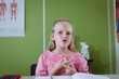 © WavebreakMediaMicro - Portrait of caucasian schoolgirl sitting at desk in classroom talking