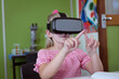 © WavebreakMediaMicro - Caucasian schoolgirl sitting at desk in classroom wearing vr headset