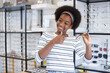 happy young woman African American afro hair smile and holding glasses standing at in the optical shop. modern ophthalmologist concept.