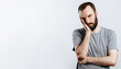 © Daria Lukoiko - Portrait of handsome young man frowning while holding hands near head on white background with space for advertising mock up