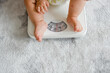Closeup of a baby's legs on a weighing scale