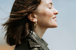 © Rawpixel.com - Side view of  a woman in leather jacket standing in a park