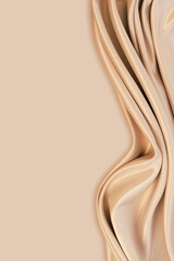 Beautiful elegant wavy light brown / beige satin silk luxury cloth fabric texture with monochrome background design. Copy space