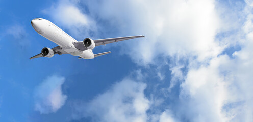 Wall Mural - airplane flying above clouds on blue sky background