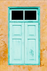 Wall Mural - Old blue vintage wooden windows and old yellow-brown cement wall