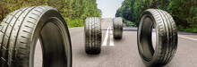 Summer Tires Roll On The Asphalt Road. The Season Of Changing Tires
