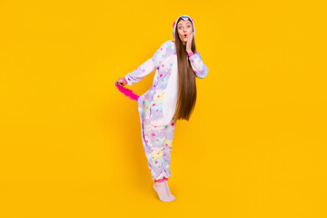 Sticker - Full length body size view of attractive cheerful funny amazed girl having fun touching tail isolated over bright yellow color background